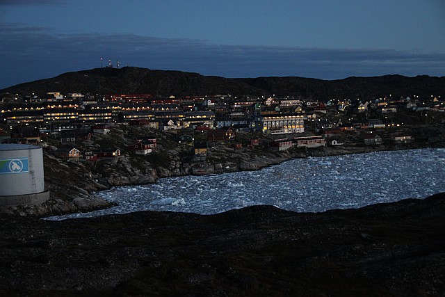 View from the hotel terrace at sunset. The town of Ilulissat sits on the hill behind the ice-filled natural harbour.