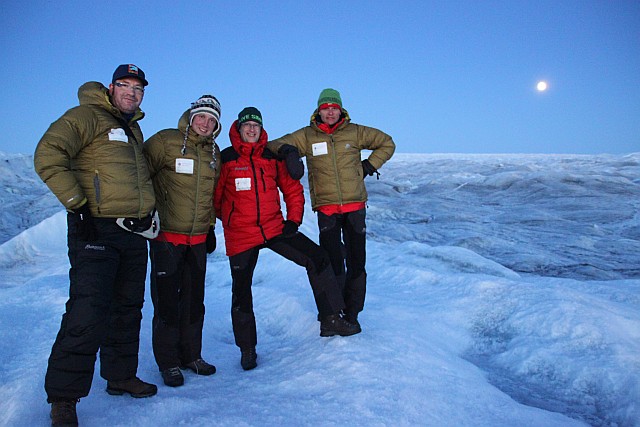 It is still twilight when the Moon rises over the horizon. Here I am posing with a few of my crewmates on an ice ridge above our lonely expedition camp.