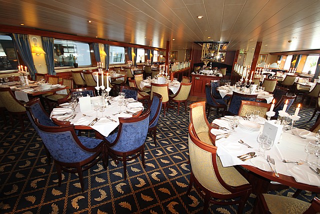 Fine dining is a key reason for tourists to go on a river cruise. The lower deck restaurant has a very luxurious ambiance, and the tables are beautifully set for a 'Captain's Dinner'.
