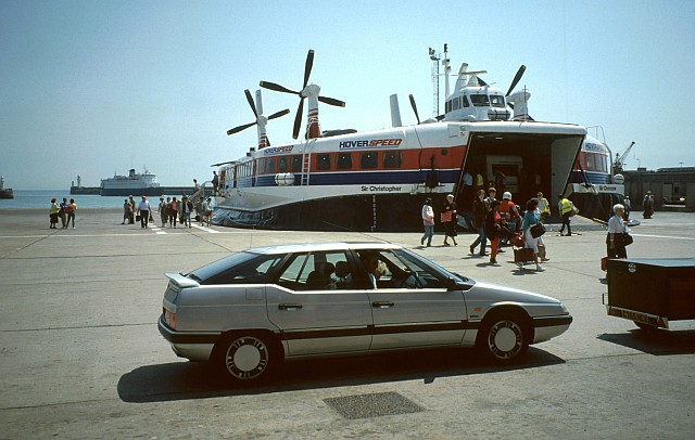The 1972-built Mark III SR.N4 hovercraft 'Sir Christopher' at Calais hoverport in July 1990. Cars waiting to get on, while returning passengers get off.