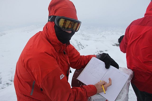 Wearing all protective gear that we have, we sign the summit book, one of the northernmost in Europe, if not the world! Unfortunately a powerful snow storm blocks most of the view.
